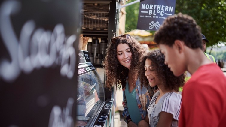 Friends buying ice-cream at the stall